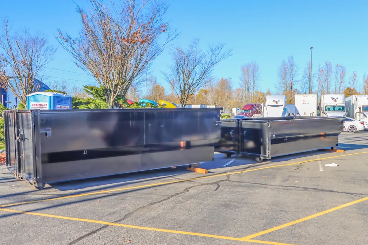 Professional dumpster rental service with roll-off container on residential driveway in Southside